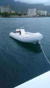 a white boat in the water with a rope at Unit was sold in Caraballeda