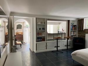 a bedroom with a bed and a desk in it at Studio swimming pool BXL in Dilbeek