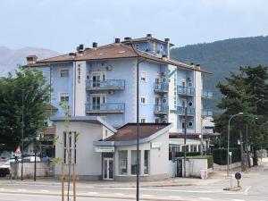 a large blue building on the side of a street at Residence Hotel Azzurro in LʼAquila