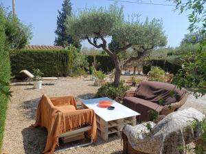 a patio with two chairs and a table in a garden at Bella Terra 2 in L'Ampolla +9 photos