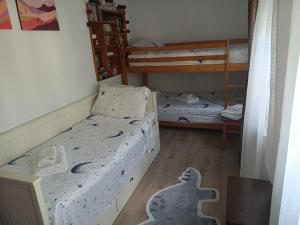 a bedroom with two beds and two bunk beds at Bella Terra 2 in L'Ampolla