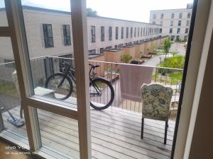 a bike is parked on a balcony at Nordic Sleep Spot in Glostrup +3 photos