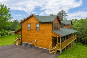 a large wooden house with a large porch at Always Dreaming by American Patriot Getaways in Hatchertown