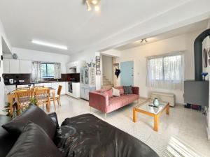 a living room with a couch and a kitchen at STAY Pervolia Maisonette in Sophtadhes