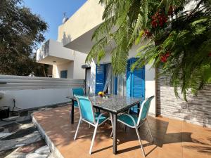 a table and chairs sitting on a patio at STAY Pervolia Maisonette in Sophtadhes