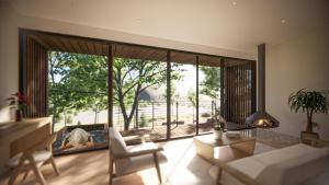 sala de estar con ventana grande y muebles blancos en Será at Sandy Ridge - Brand New Modern WV Retreat, en Wardensville