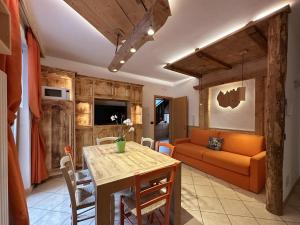 a living room with a table and a couch at Casa Dorigoni Molveno in Molveno
