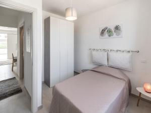 a white bedroom with a bed and a table at Modern Villa Near Trapani in Locogrande +31 photos