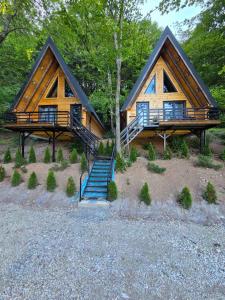 a log cabin with a staircase in front of it at Visitor Place in Plav +20 photos