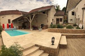 a backyard with a swimming pool and a house at Gite de Bourgogne in Sainte-Marie-sur-Ouche