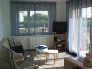 a living room with a couch and a table and a tv at Holiday Home in Audresselles by Seacoast in Audinghen +32 photos