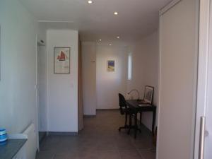 a hallway with a desk and a table in a room at Holiday Home in Audresselles by Seacoast in Audinghen