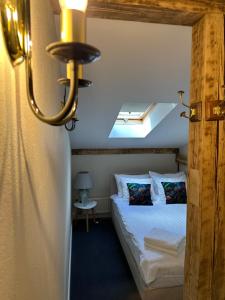 a bedroom with a bed in a room with a window at Igates pils in Myza Igate
