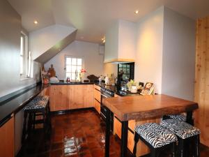 a kitchen with a wooden counter top in a room at Villa in Ommen with Private Pond in Rheezerveen