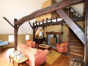 a living room with couches and a fireplace at Villa in Ommen with Private Pond in Rheezerveen