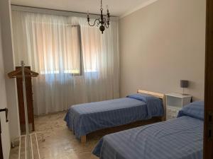 a room with two beds and a window at Appartamento Mare Monti in Carrara