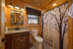 a bathroom with a toilet and a sink at Anglers Ridge by American Patriot Getaways in Richardson Cove +30 photos