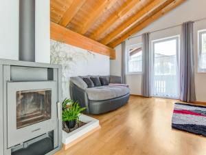 a living room with a couch and a fireplace at Apartment near Gondola in Tyrol in Holzhamm