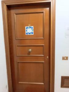a wooden door with a drawer in a room at ROSA BLU House in Pisa
