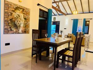 a dining room with a wooden table and chairs at King Royal - Tangalle in Tangalle