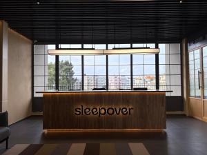 a lobby with a sleepover counter in front of windows at Sleepover in Bengaluru