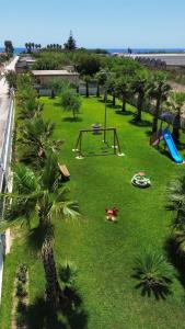 a park with a playground with palm trees at Villa acqua e sale in Santa Maria Del Focallo