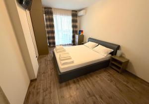 une petite chambre avec un lit dans une pièce dans l'établissement Уютен двустаен Гранд мол, à Varna