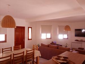 a living room with a couch and a table at La Carmela, Tilcara in Tilcara