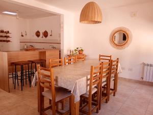 a kitchen and dining room with a table and chairs at La Carmela, Tilcara in Tilcara
