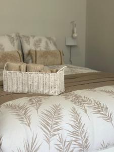 a bedroom with a bed with a white blanket with palm leaves at T2 cosy Vieux Port de Marseille in Marseille