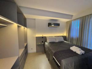 a small bedroom with a bed and a window at Studio b2b in Florianópolis +30 photos