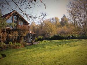 a house on a grassy yard with a large yard at Wellness & Adventure Escape in Niderviller