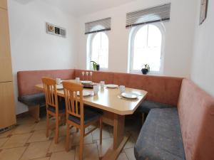 a dining room with a wooden table and chairs at Mansion in Goldegg near Ski Lift in Goldegg