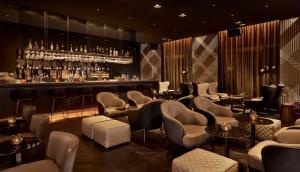 a bar with a bunch of chairs and a counter at Park Plaza Victoria Amsterdam in Amsterdam +70 photos