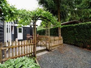 a wooden fence in front of a house at Chalet in Veluwe near Sauna Drôme in Putten