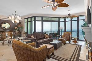 a living room with a couch and chairs at Phoenix West 1103 in Orange Beach