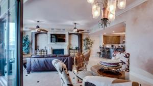 a dining room and living room with a table and chairs at Phoenix West 1103 in Orange Beach