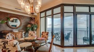 a dining room with a table and chairs and a balcony at Phoenix West 1103 in Orange Beach +31 photos