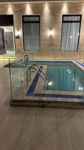 a swimming pool in a building with a swimming pooliterator at Abayah resort عبية ريزورت in Hail