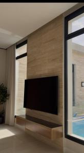 a flat screen tv on a wall in a living room at Abayah resort عبية ريزورت in Hail