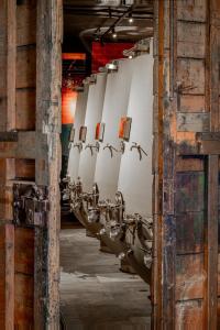 a row of urinals lined up in a building at Cantina Semonte Wine Resort in Gubbio +24 photos