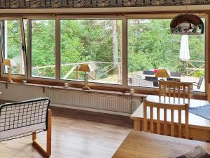 a living room with a table and a large window at 7 person holiday home in Spekeröd-By Traum in Bräcketorp +9 photos
