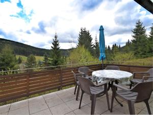 a patio with a table and chairs and an umbrella at Mountain Hideaway in Wildenthal in Weitersglashütte
