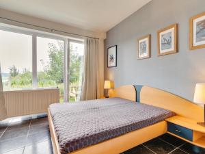 a bedroom with a bed and a large window at Ferienwohnung in der Nähe von Skipisten in Winterberg