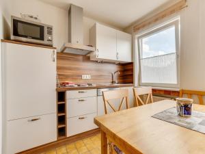a kitchen with a wooden table and a refrigerator at Ferienwohnung in der Nähe von Skipisten in Winterberg