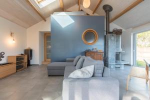 a living room with a couch and a table at La Préfaillaise - 800m plage - Parking in Préfailles