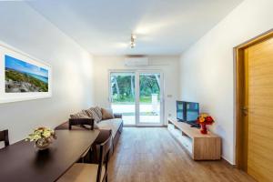 a living room with a couch and a tv at Apartment Lili in Biograd na Moru