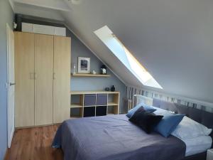 a bedroom with a bed with blue pillows at Dormare in Grzybowo +33 photos