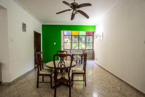 a dining room with green walls and a table and chairs at APT Perto da praia de Copacabana in Rio de Janeiro +13 photos