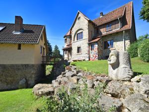 a stone lion statue in front of a house at WunderVilla in Hessen in Waldnähe in Vöhl